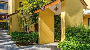 A yellow building with a covered entrance, a sign reading "Villa 02", and lush greenery. - Hoa Co Villas (Da Nang)