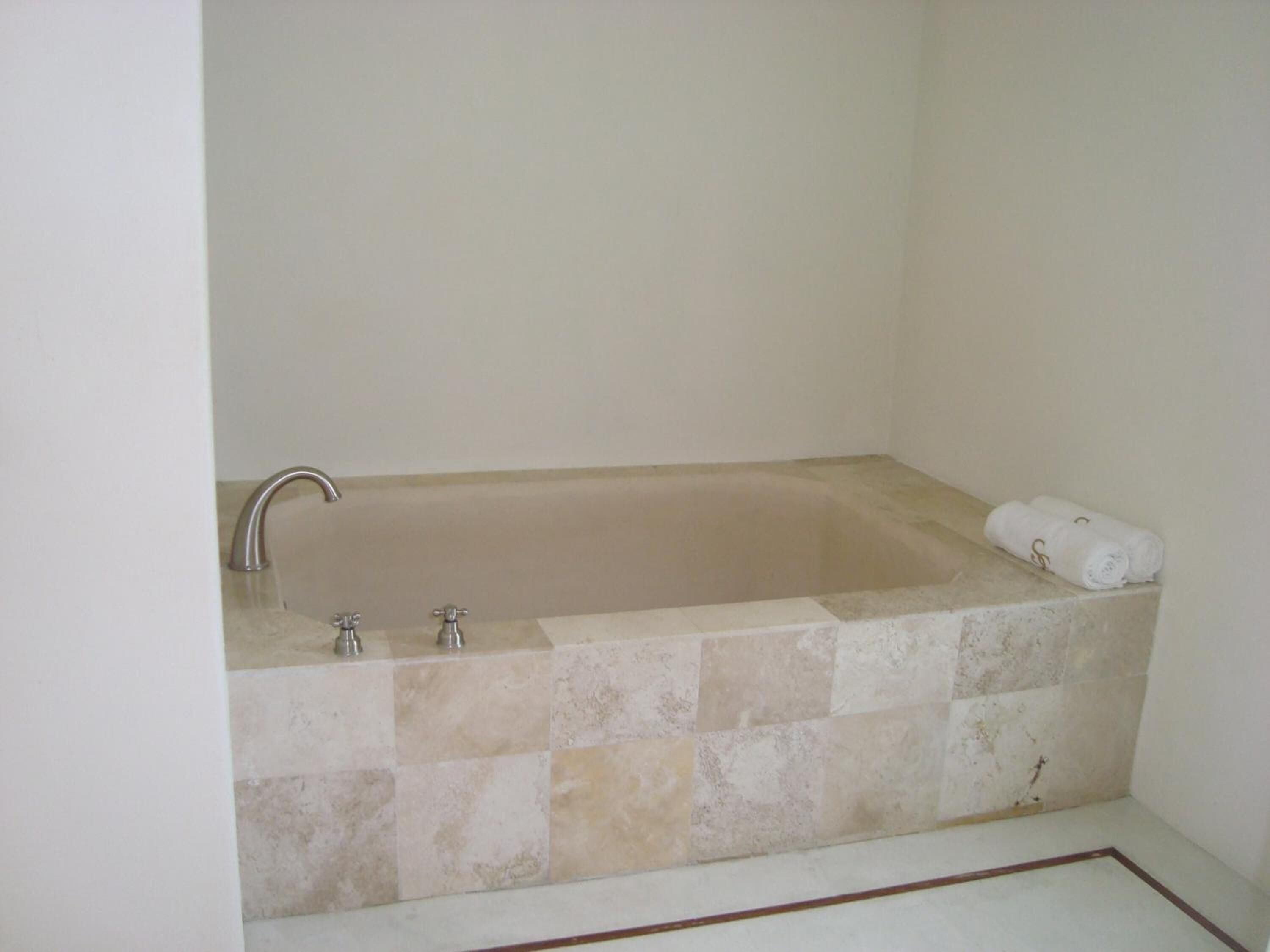 A bathroom with a bathtub, a shower, and a toilet.