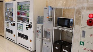 A row of vending machines and a microwave in a public area. - Toyoko Inn Tsushima Izuhara (Tsushima)