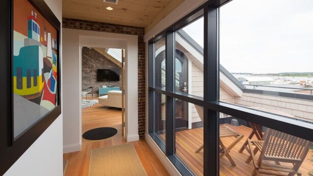 A balcony with wooden flooring and a view of the cityscape. - Old Port Penthouse Suite - Amazing Harbor Views (Portland)