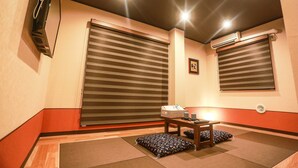 A room with a sliding door, a table with a basket, a pillow, and an air conditioning unit. - Asakusa No Yado Hanaakari (Tokyo)