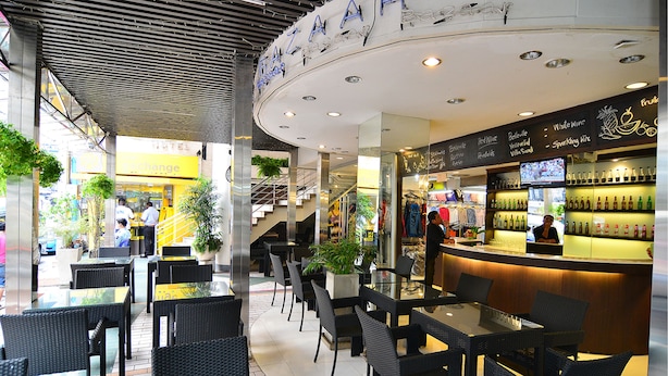 A modern restaurant with a curved ceiling and a bar area. - The 93 Hotel (Bangkok)