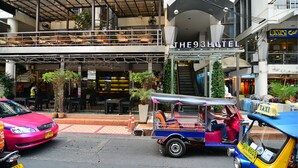 A hotel with a modern architectural design, featuring a prominent entrance and a visible upper balcony. - The 93 Hotel (Bangkok)