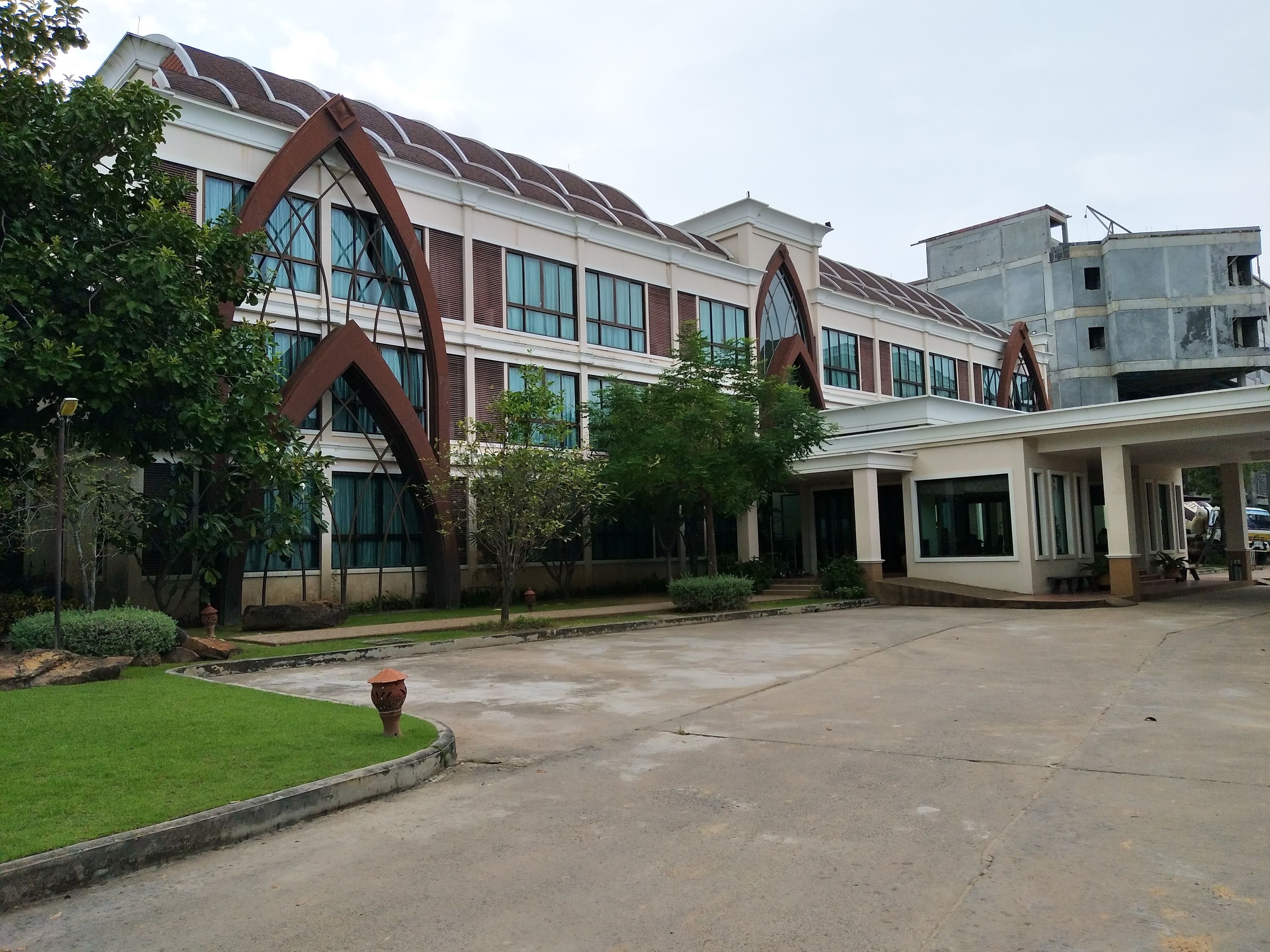 A modern building with large windows and a covered entrance area.