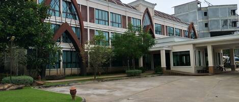 A modern building with large windows and a covered entrance area.
