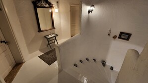 A staircase with a white wall and a door at the top. - Jakamar Alacati (Cesme)