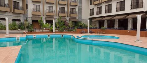 Outdoor pool, open 6:00 AM to 6:30 PM, pool umbrellas