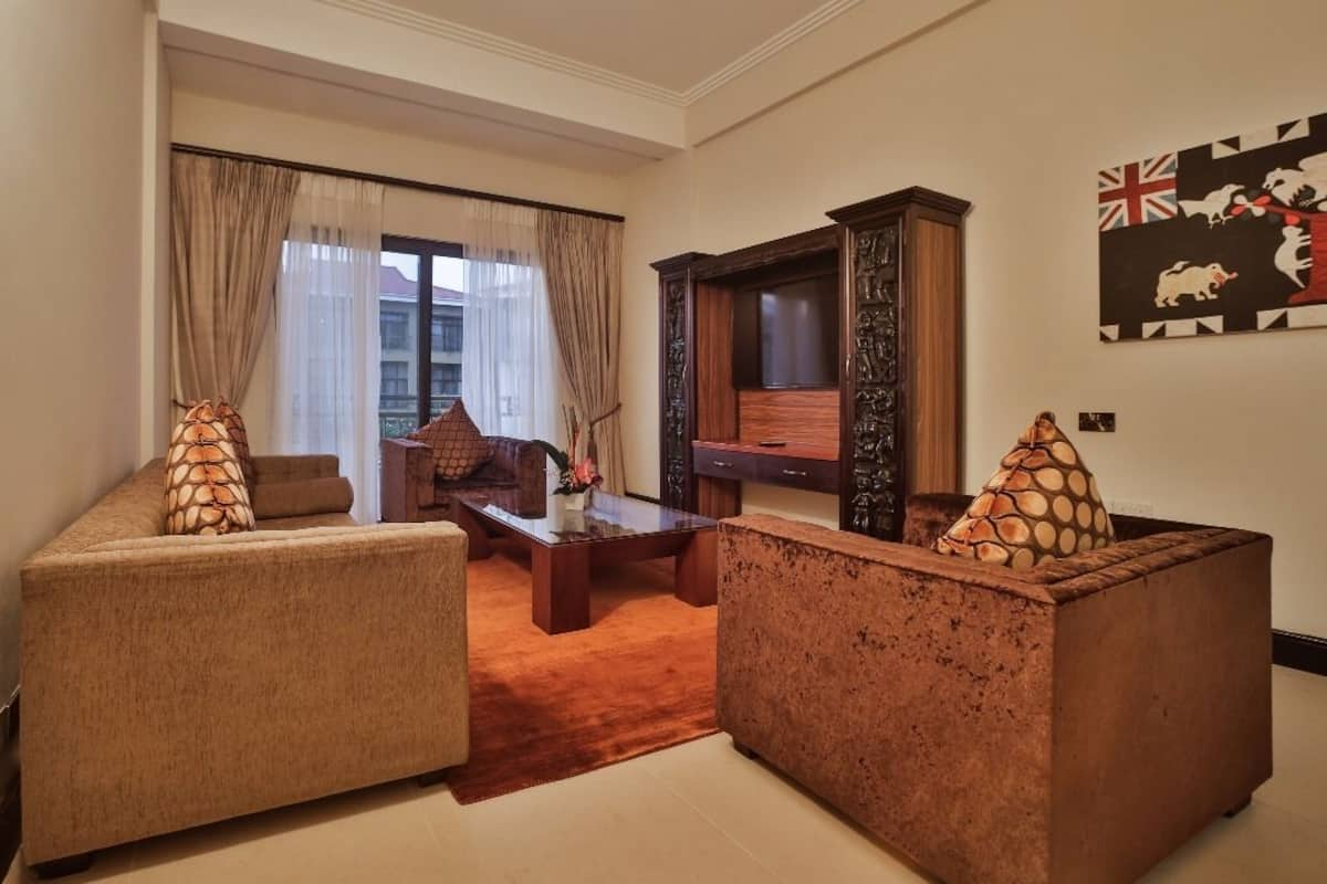 Presidential Suite | Living area | 40-inch flat-screen TV with cable channels, TV, pay films