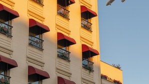 A building with multiple balconies, each with red awnings and potted plants. - Classes Hotel (Istanbul)