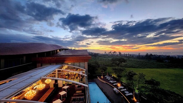 A modern building with a glass-enclosed lounge area and a pool. - Camphortree Hotel & Resort (Jeju City)