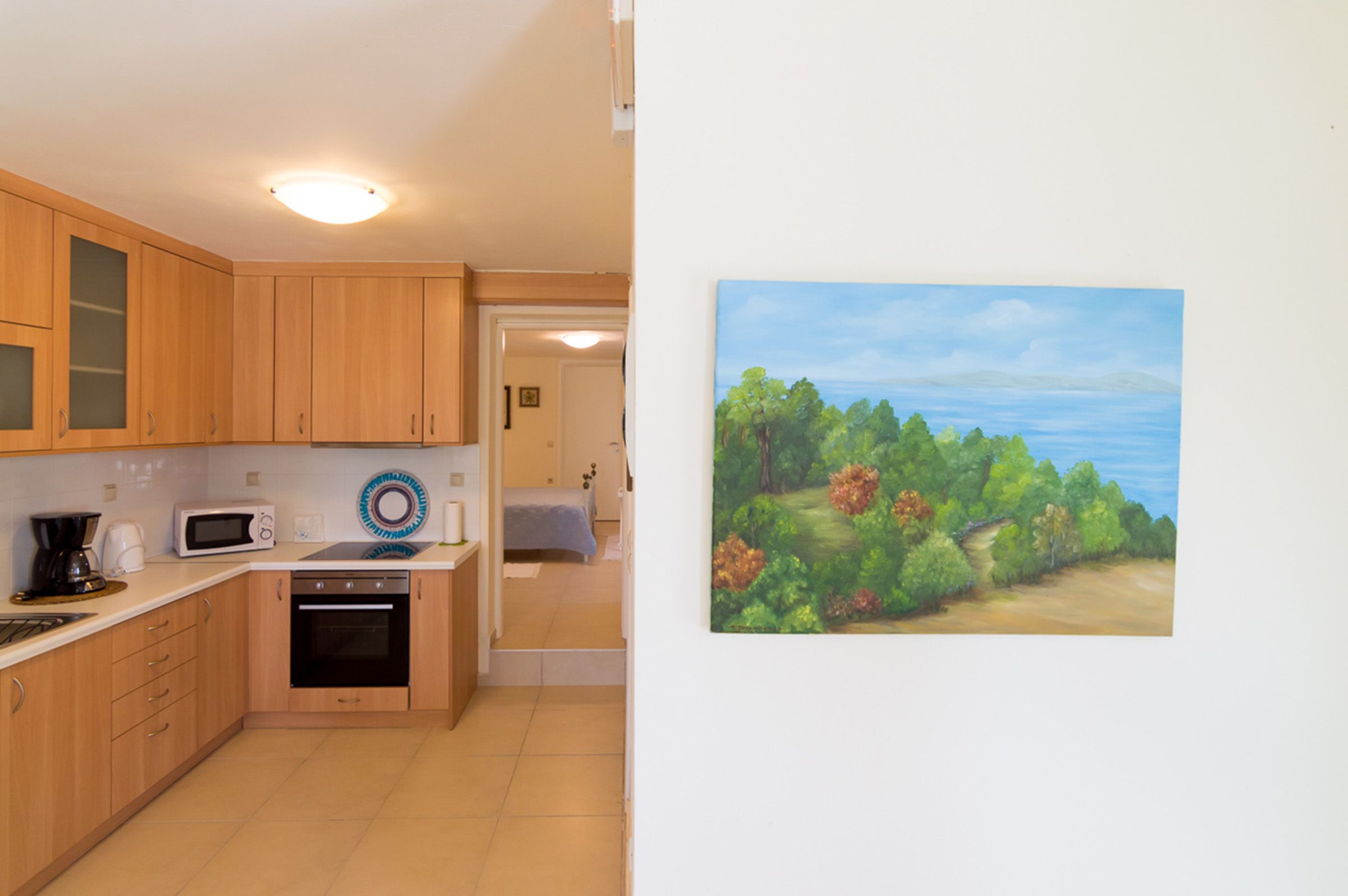 A kitchen with wooden cabinets, a microwave, and a coffee maker.