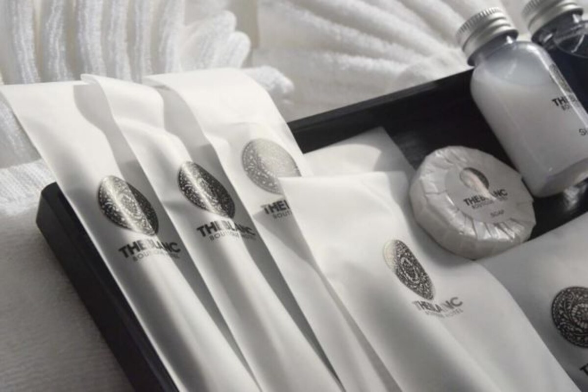 A set of toiletries including a bottle, a tube, and a container, all branded with "THE HANC".