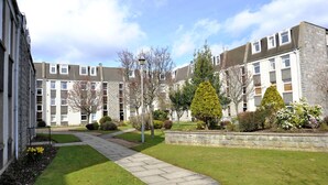A courtyard with a stone pathway, surrounded by multi-story residential buildings with balconies and windows. - Home from Home Aberdeen (Aberdeen)
