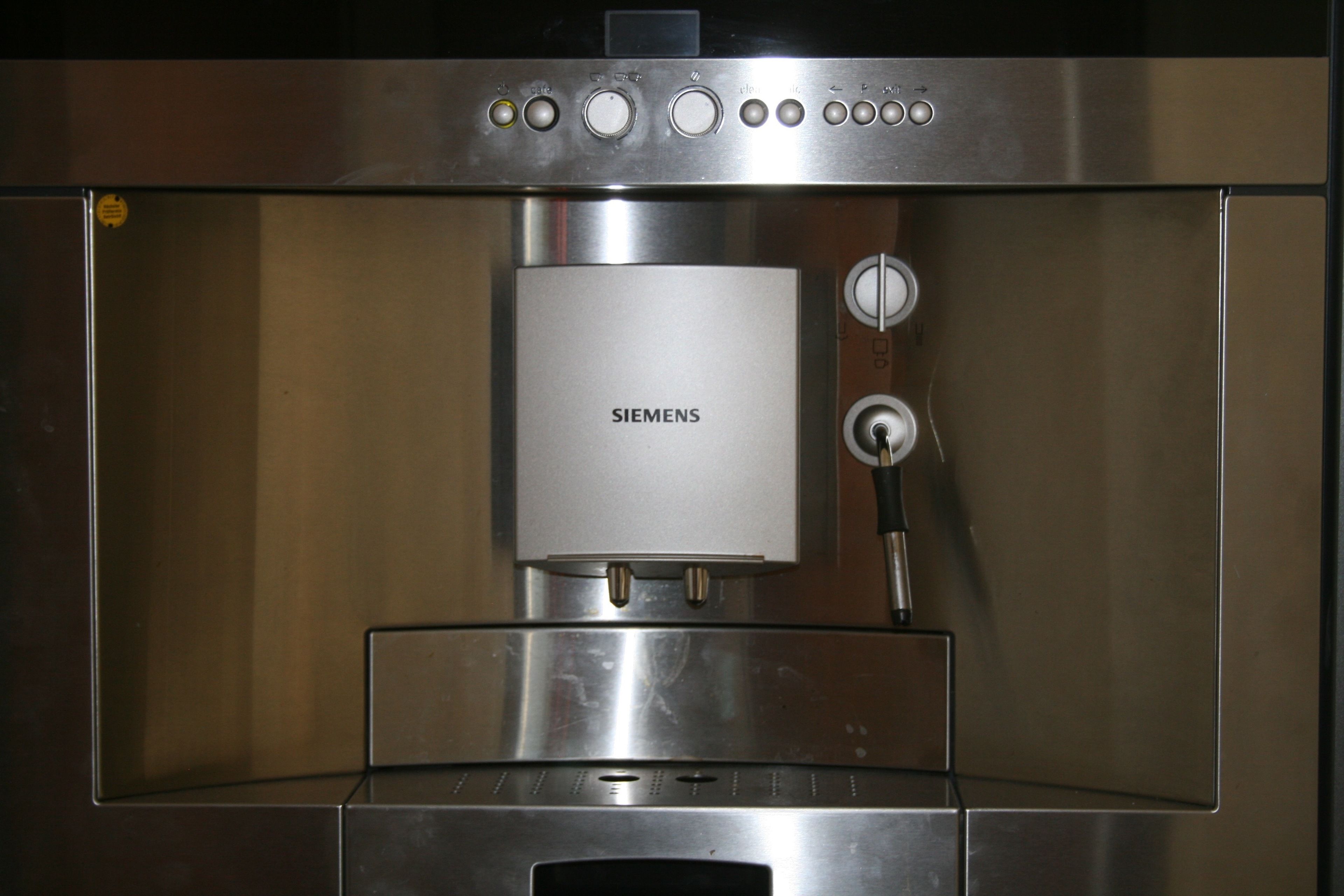 Eine Edelstahl-Espressomaschine mit Bedienfeld und Wasserbehälter.