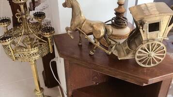 A wooden cabinet with a horse figurine and a carriage on top.