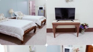 A hotel room with two beds, a TV, a small table, a refrigerator, and a microwave. - Chanathinat Place (Udon Thani)