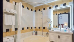 A modern bathroom with a bathtub, toilet, and vanity with a mirror. - A25 Premium Hotel - 20 Bui Thi Xuan (Ho Chi Minh City)