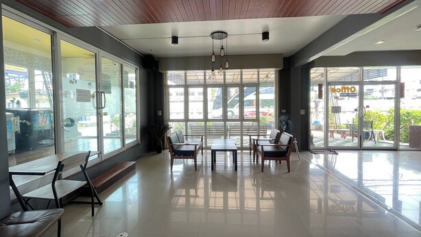A spacious indoor area with a wooden ceiling, large windows, and a seating arrangement. - Bann Lhong Rak Krabi (Krabi)