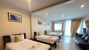 A hotel room with three beds, a sofa, and two paintings on the wall. - Bann Lhong Rak Krabi (Krabi)