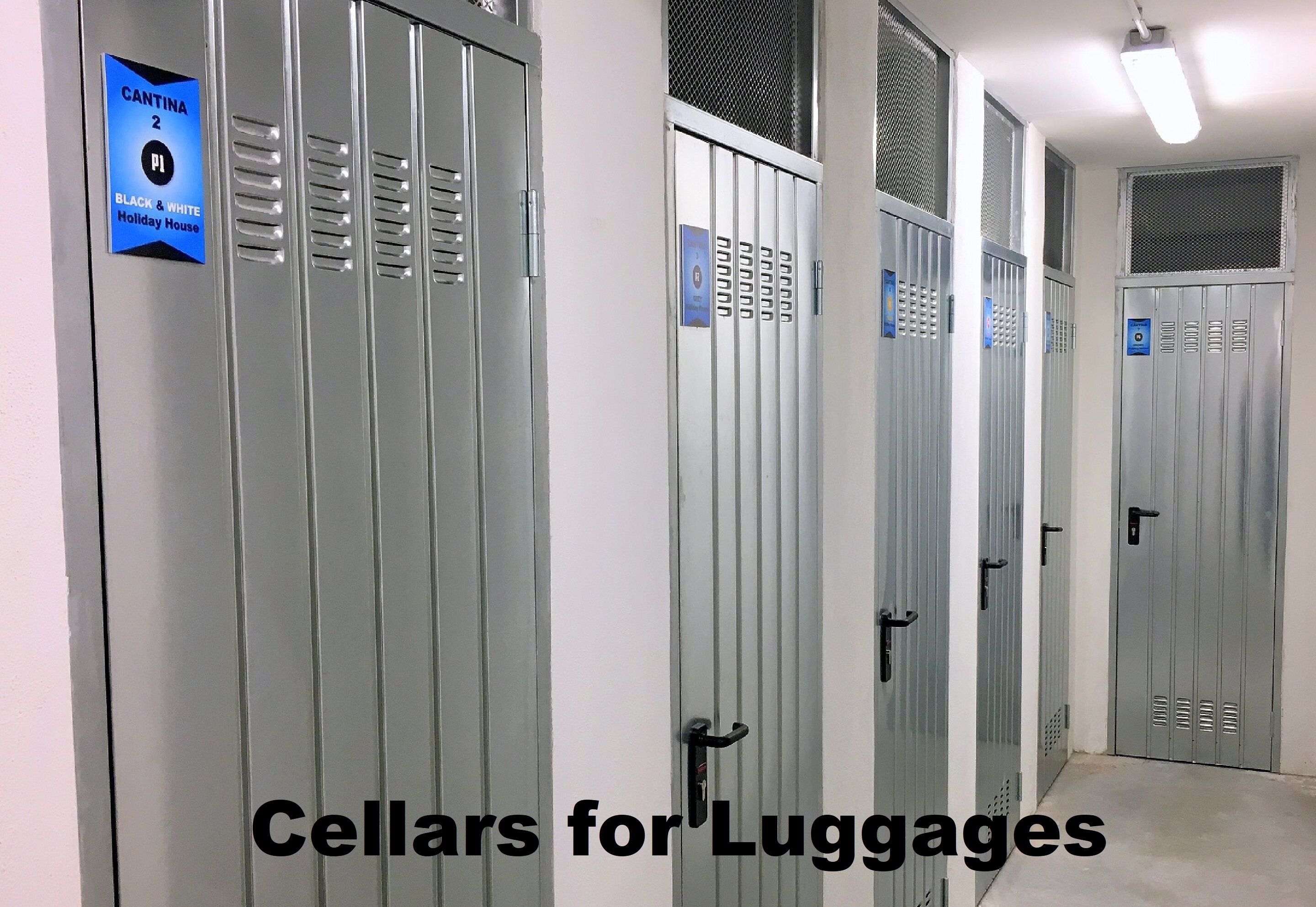 A row of metal lockers with a sign indicating 'CANTINA 2' and 'BLACK & WHITE Holiday House'.