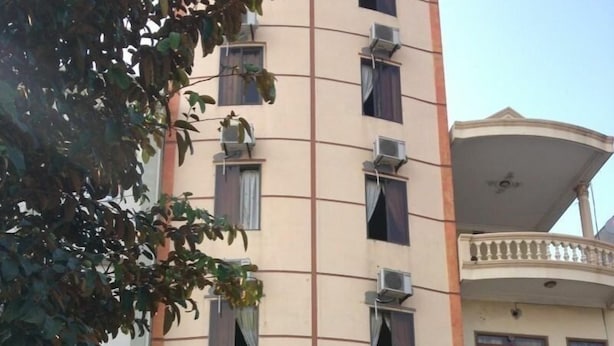 A hotel with a beige facade, multiple air conditioning units, and a sign reading "HOTEL KOCMOCH HA". - Kocmoc Ha Long (Ha Long)