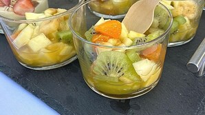 A variety of fruit-based desserts in clear glasses with wooden spoons. - Hostal Cling 43 (Deltebre)