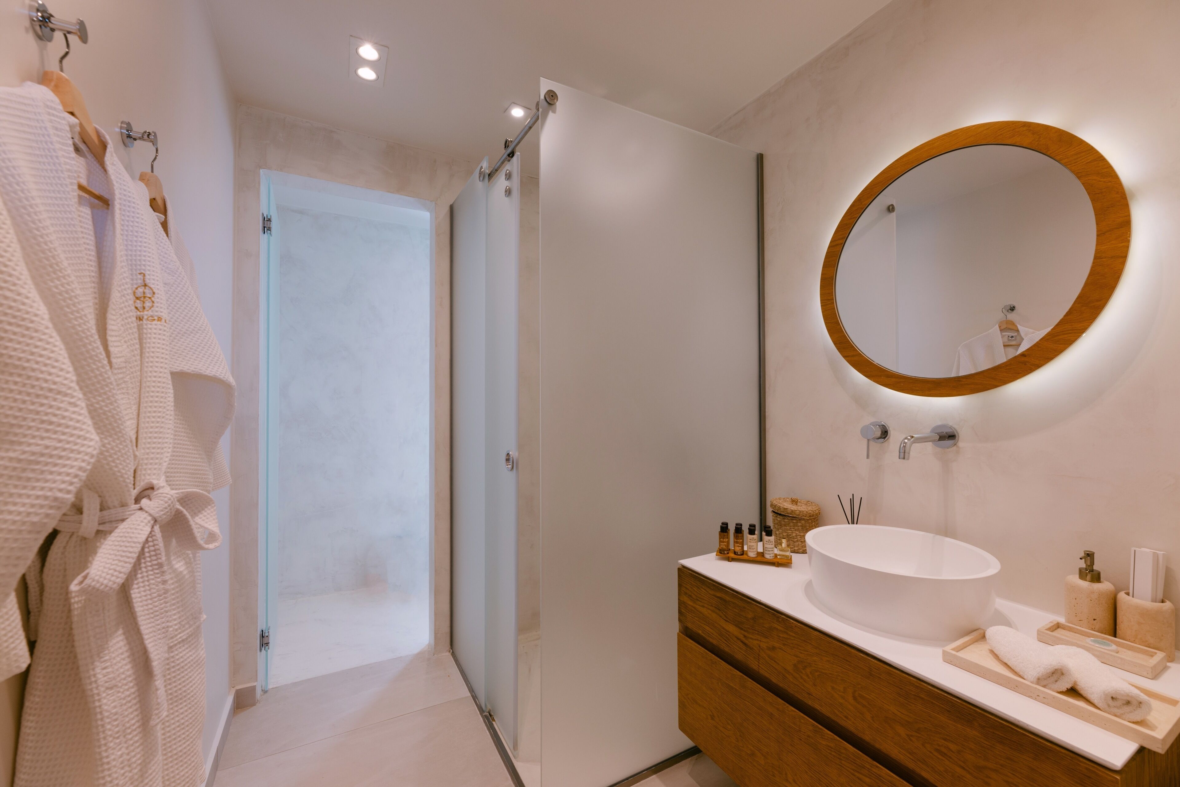 partial sea view room with private garden and outdoor hot tub | bathroom | shower, designer toiletries, hair dryer, slippers