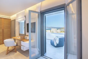A modern bathroom with a shower, toilet, and sink. - 18 Grapes Hotel (Naxos)