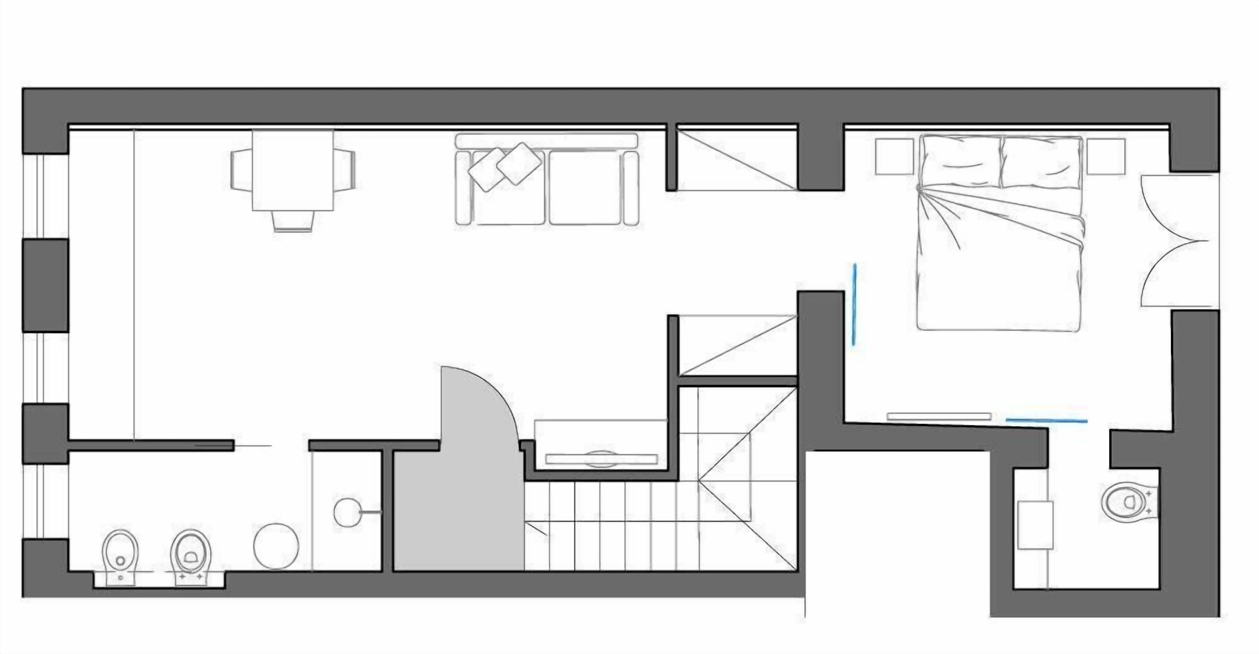 A floor plan of a hotel room with a bed, a desk, a chair, a small table, and a bathroom.