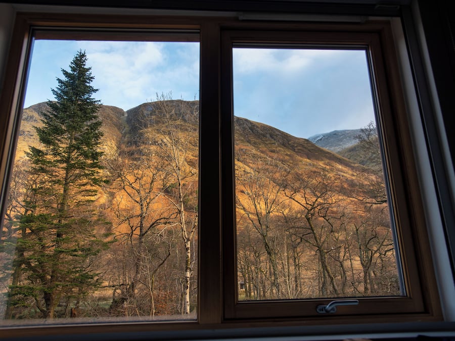 A window with a view of a mountainous landscape.