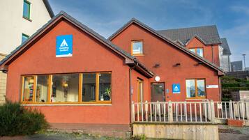 A hostel with a reception area, a Youth Hostel sign, and a reception sign.