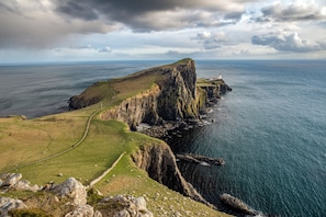A coastal landscape with a grassy path leading to a cliff edge overlooking the sea. - Portree Youth Hostel (Portree)