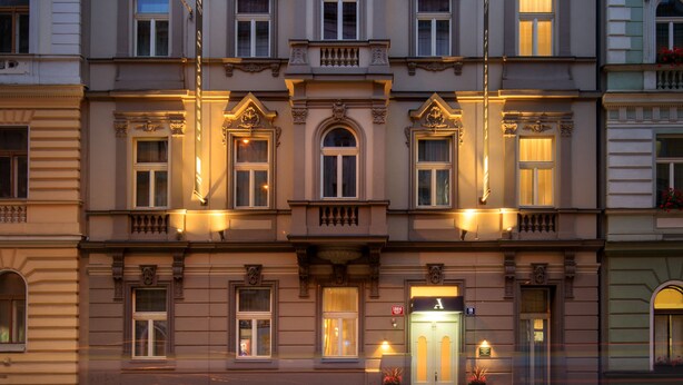 A multi-story building with a classic architectural style, featuring a central entrance with a door and windows on each floor. - Avenue Legerova 19 (Prague)
