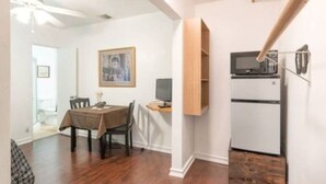 A compact living space with a dining area, a small kitchenette, and a ceiling fan. - Summer Leaf (Reseda)