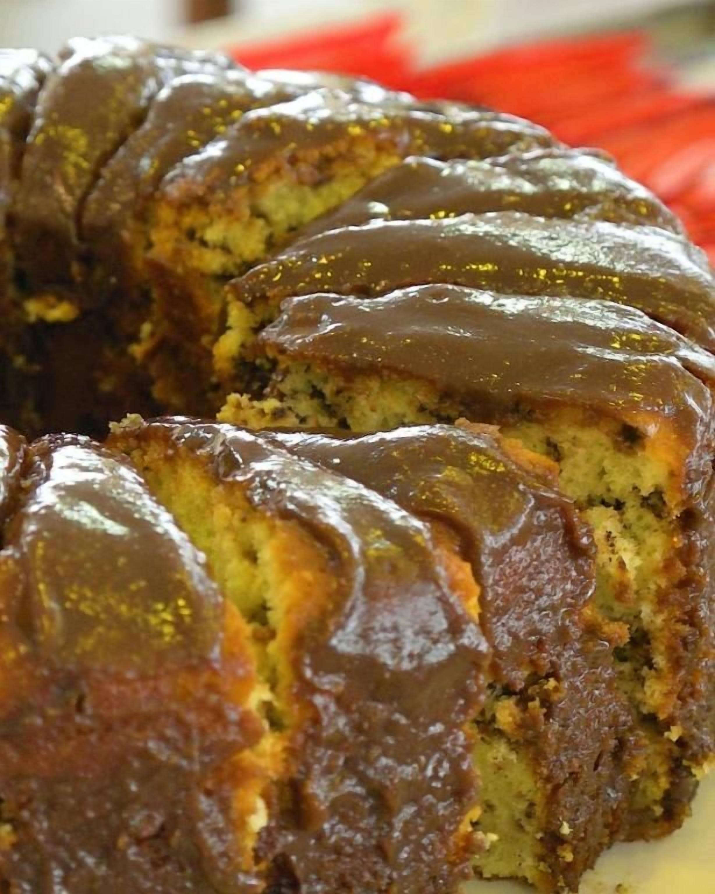 A chocolate-glazed bundt cake with a golden-brown crust.