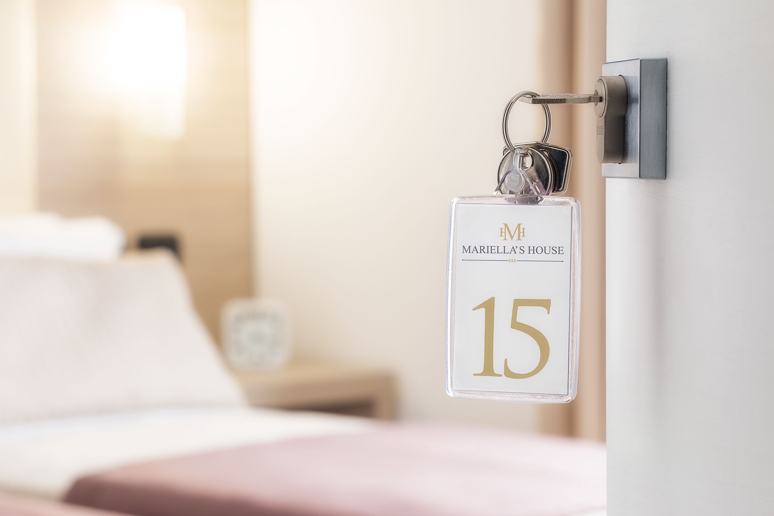 A keychain with 'MARIELLA'S HOUSE' and the number '15' on a door handle.