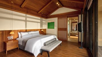 A modern bedroom with a wooden ceiling, a large bed, a bench, a nightstand, and a TV.