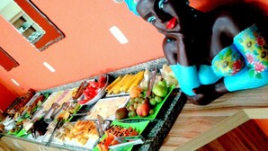 Un buffet proposant une variété de plats et agrémenté d’une figurine décorative.