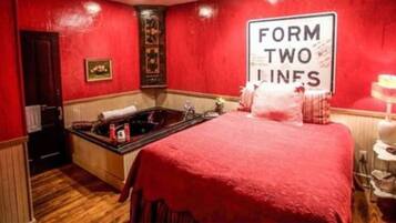 Relax in this cozy space with a comfortable bed, a bathtub, and a convenient table for your essentials.