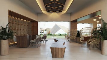 A spacious lobby with a high ceiling featuring a geometric wooden design, a reception desk, seating area, and a view of the outdoors.