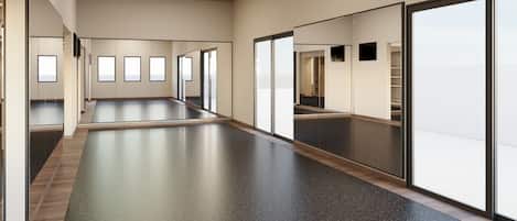 Un pasillo espacioso con piso pulido, ventanas amplias y un diseño moderno en el techo.