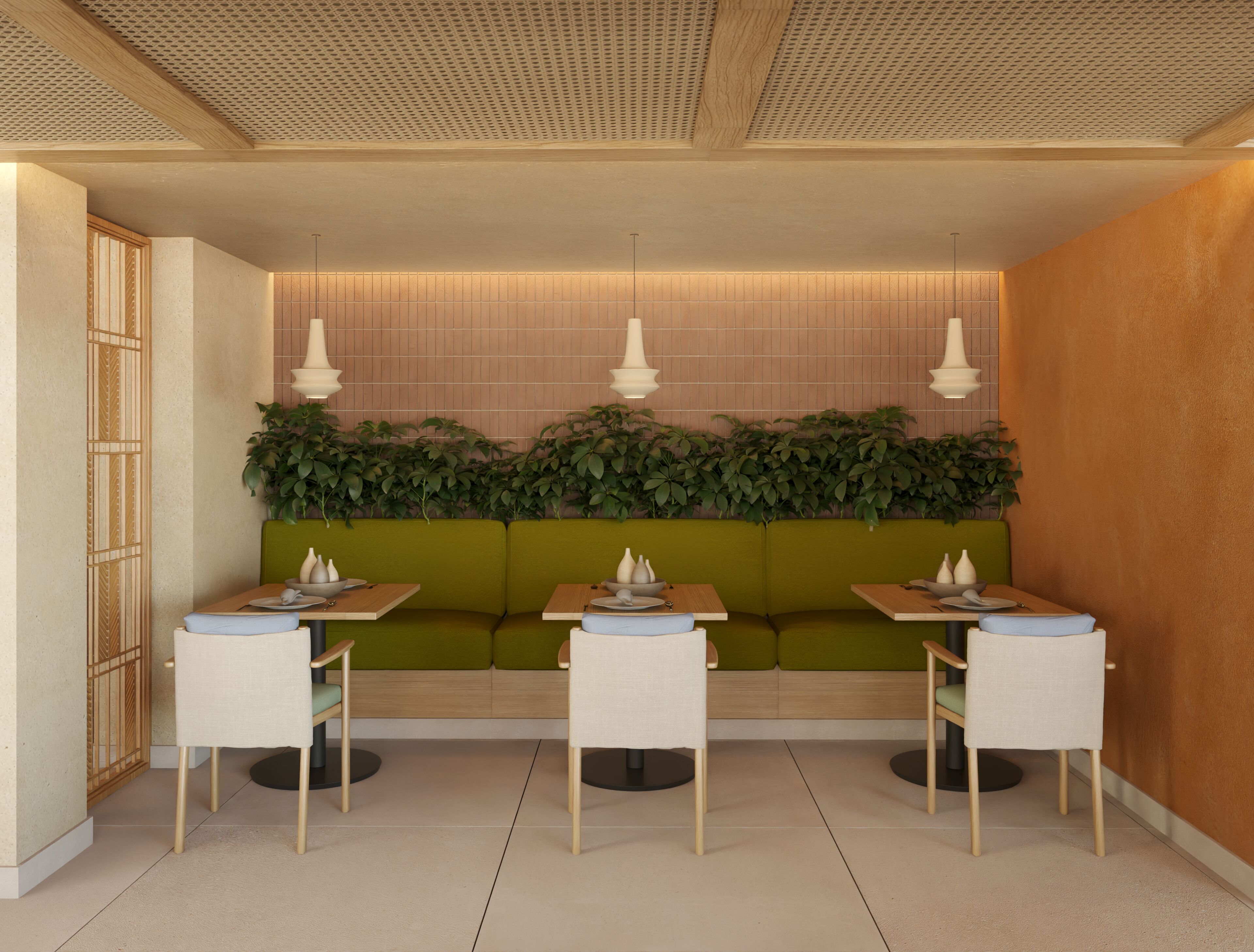 Un restaurante con una zona de asientos en cabina verde, mesas de madera e iluminación colgante.