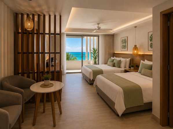 Habitación de hotel con dos camas, una zona de estar con mesa y vista al océano.
