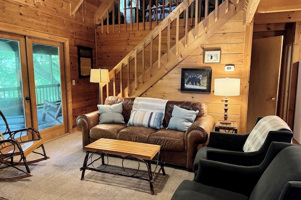 Living space with doors leading to screened in porch