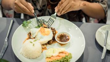 A plate of food with rice, vegetables, and a fried egg.