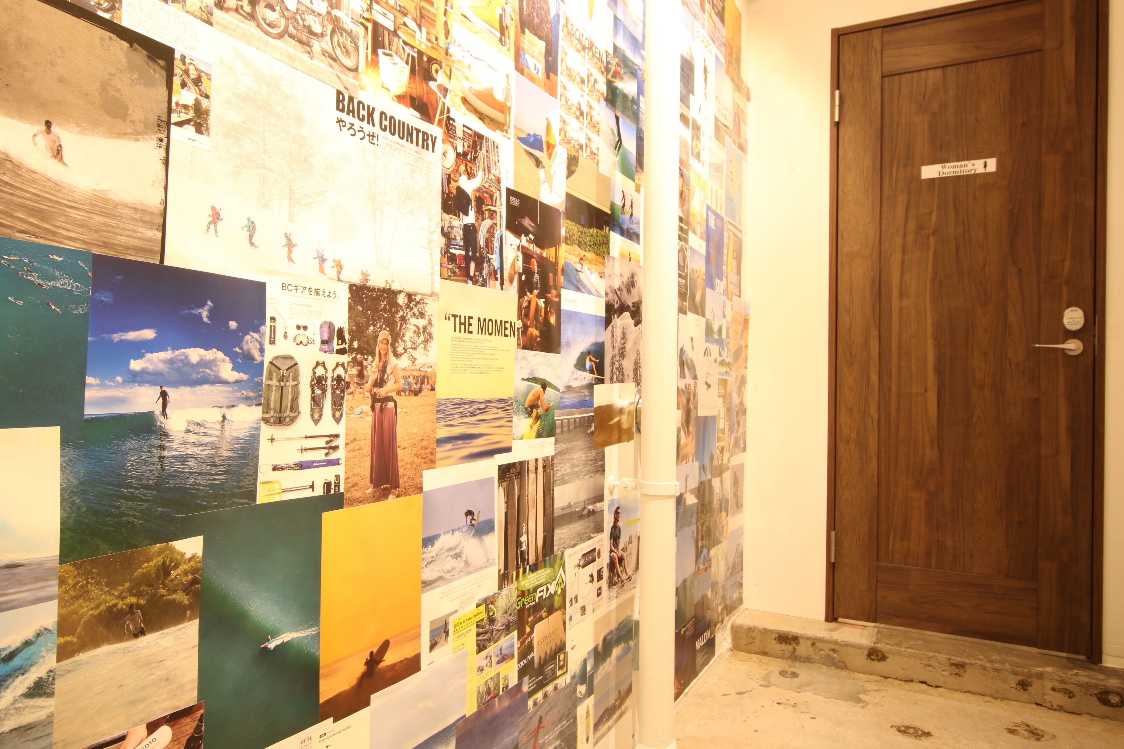 A wall covered with various photographs and posters, including images of people and landscapes.