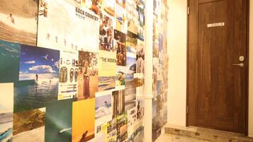 A wall covered with various photographs and posters, including images of people and landscapes.