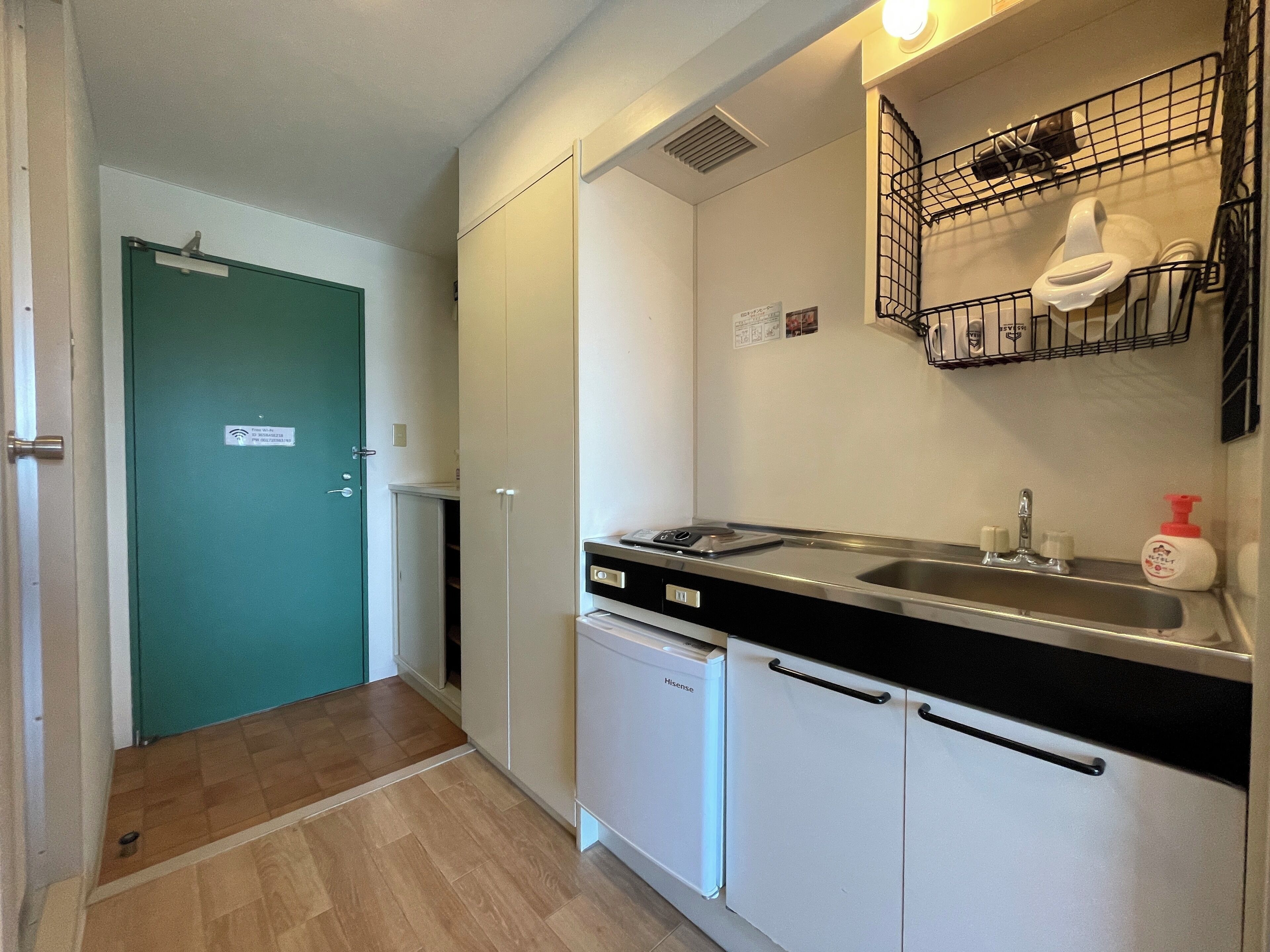 A compact kitchen with a sink, a dishwasher, and a countertop.