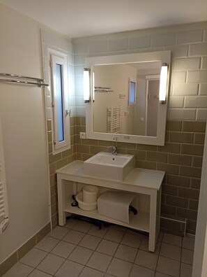 Een haardroger, handdoeken, zeep, toiletpapier