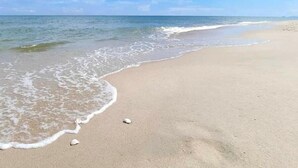 A beach with clear skies and gentle waves. - The Energy Condo By AP (Cha-am)